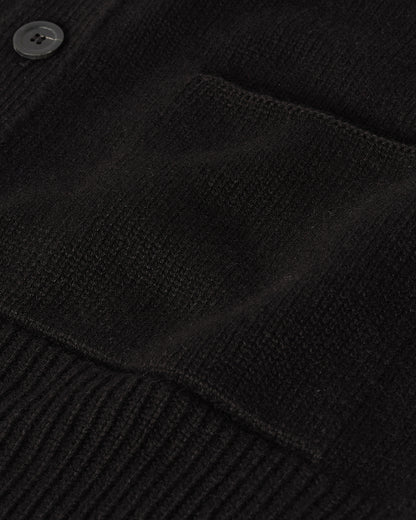 Johnstons of Elgin AW25 Men's Knitwear Black Ribbed Cashmere Black Cardigan worn over a black t-shirt, showing button details  KAC05601SA7210