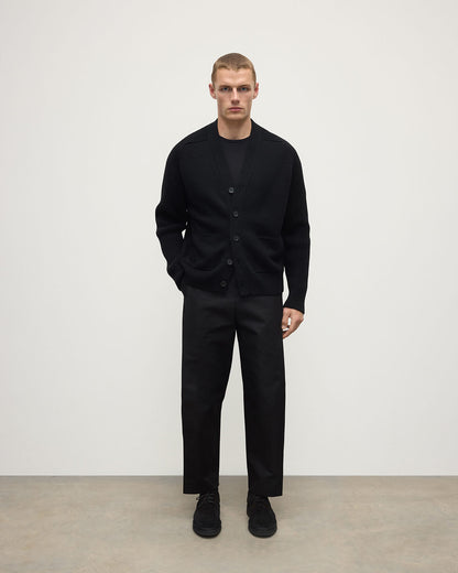 Johnstons of Elgin AW25 Men's Knitwear Black Ribbed Cashmere Black Cardigan worn over a black t-shirt with blank trousers KAC05601SA7210