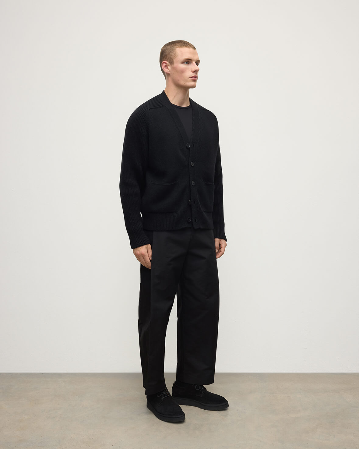 Johnstons of Elgin AW25 Men's Knitwear Black Ribbed Cashmere Black Cardigan worn over a black t-shirt KAC05601SA7210