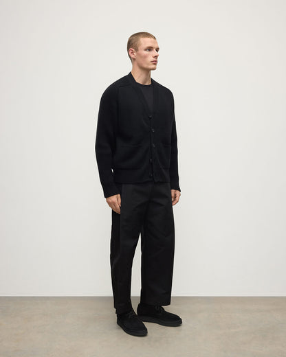 Johnstons of Elgin AW25 Men's Knitwear Black Ribbed Cashmere Black Cardigan worn over a black t-shirt KAC05601SA7210