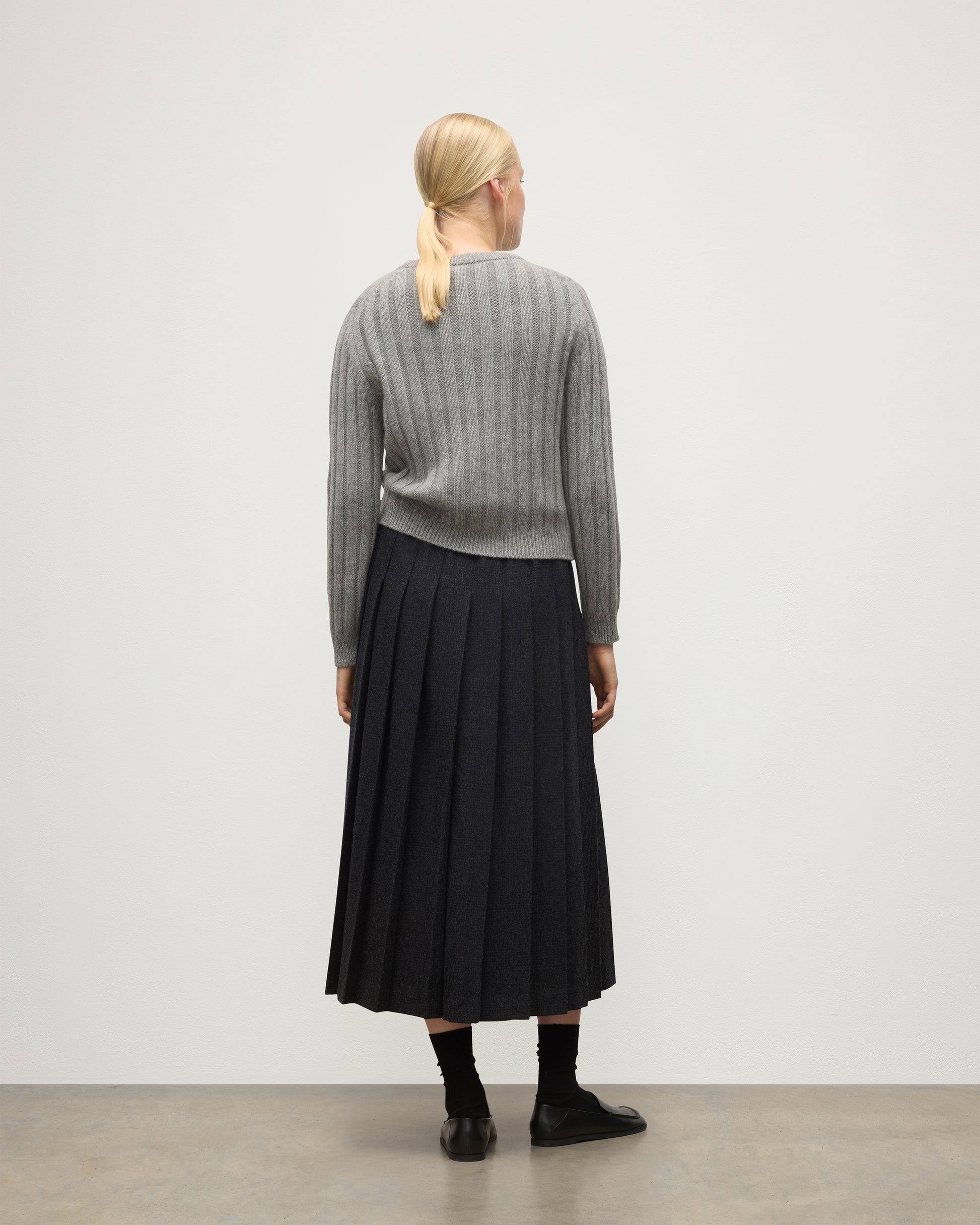 BACK OF JOHNSTONS OF ELGIN WOMENS LECHT CREW SWEATER GREY 100% CASHMERE ON A MODEL WORN WITH A LONG LE KILT CHARCOAL KILT KAC05706HA0400