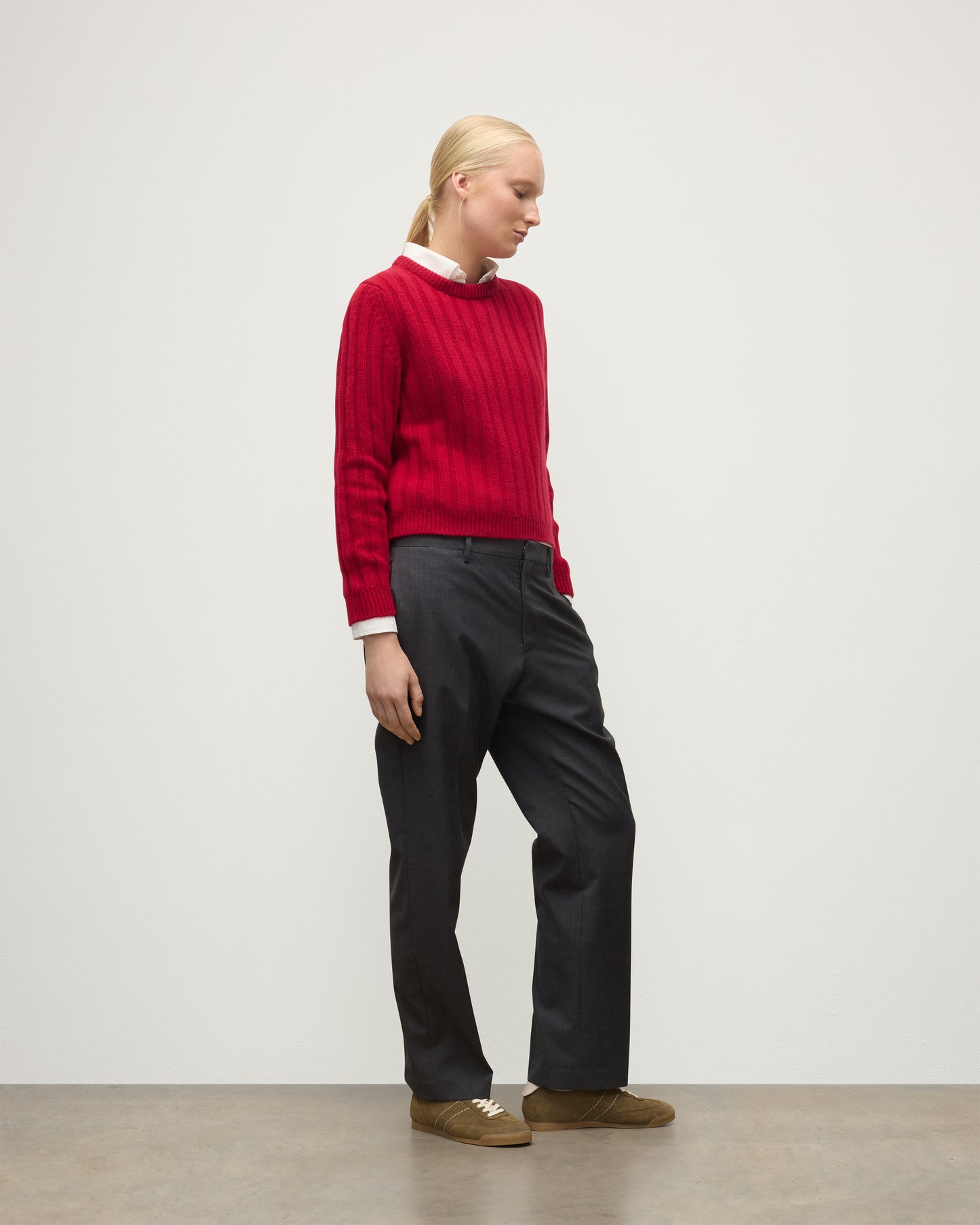 MODEL WEARING JOHNSTONS OF ELGIN WOMENS LECHT CREW SWEATER RED OVER WHITE SHIRT WITH GREY TROUSERS ANDTRAINERS  KAC05706SE5325