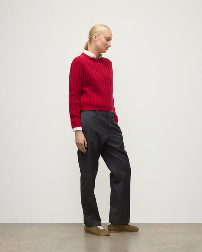 MODEL WEARING JOHNSTONS OF ELGIN WOMENS LECHT CREW SWEATER RED OVER WHITE SHIRT WITH GREY TROUSERS ANDTRAINERS  KAC05706SE5325