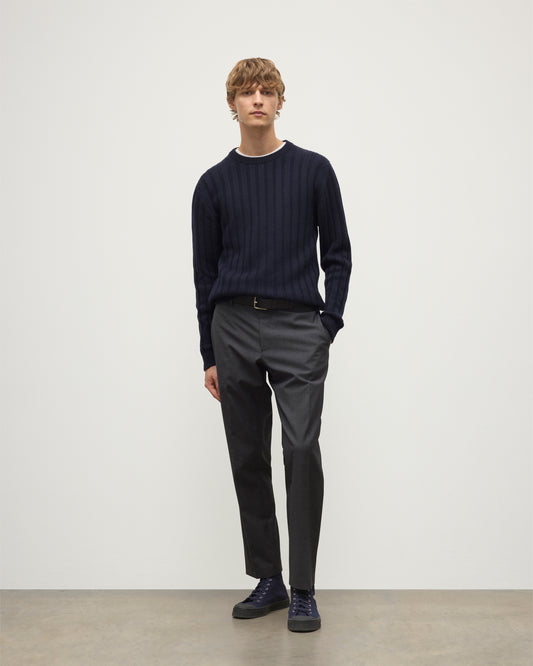 MODEL WEARS JOHNSTONS OF ELGIN MENS PEEL CREW SWEATER NAVY OVER A WHITE T-SHIRT WITH GREY TROUSERS KAC05751SD7666