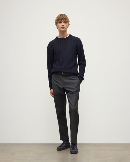 MODEL WEARS JOHNSTONS OF ELGIN MENS PEEL CREW SWEATER NAVY OVER A WHITE T-SHIRT WITH GREY TROUSERS KAC05751SD7666