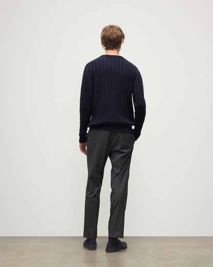 MODEL WEARS JOHNSTONS OF ELGIN MENS PEEL CREW SWEATER NAVY OVER A WHITE T-SHIRT WITH GREY TROUSERS KAC05751SD7666