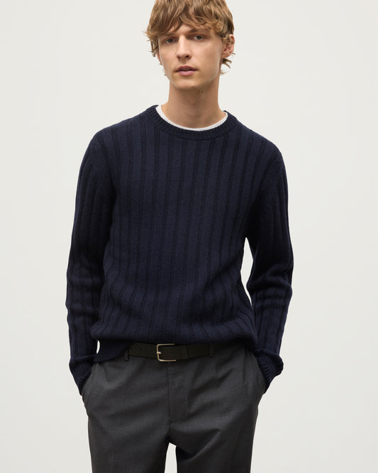 MODEL WEARS JOHNSTONS OF ELGIN MENS PEEL CREW SWEATER NAVY OVER A WHITE T-SHIRT WITH GREY TROUSERS KAC05751SD7666
