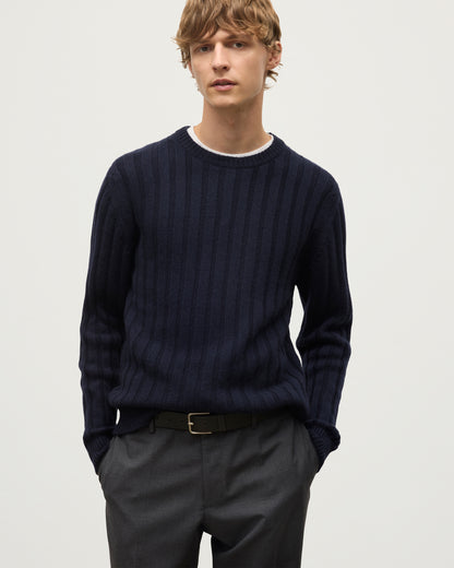 MODEL WEARS JOHNSTONS OF ELGIN MENS PEEL CREW SWEATER NAVY OVER A WHITE T-SHIRT WITH GREY TROUSERS KAC05751SD7666