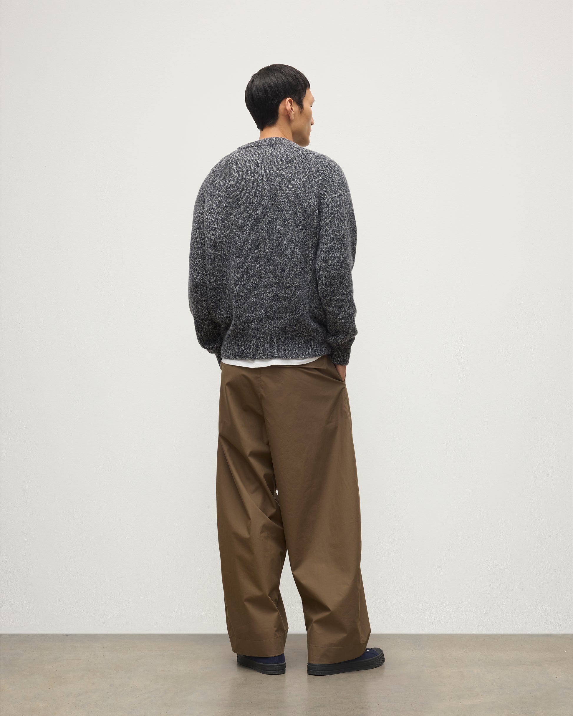 MALE MODEL WEARS JOHNSTONS OF ELGIN FYFE CREW SWEATER NAVY 100% CASHMERE OVER WHITE T-SHIRT AND BROWN TROUSERS  KAC05753006876