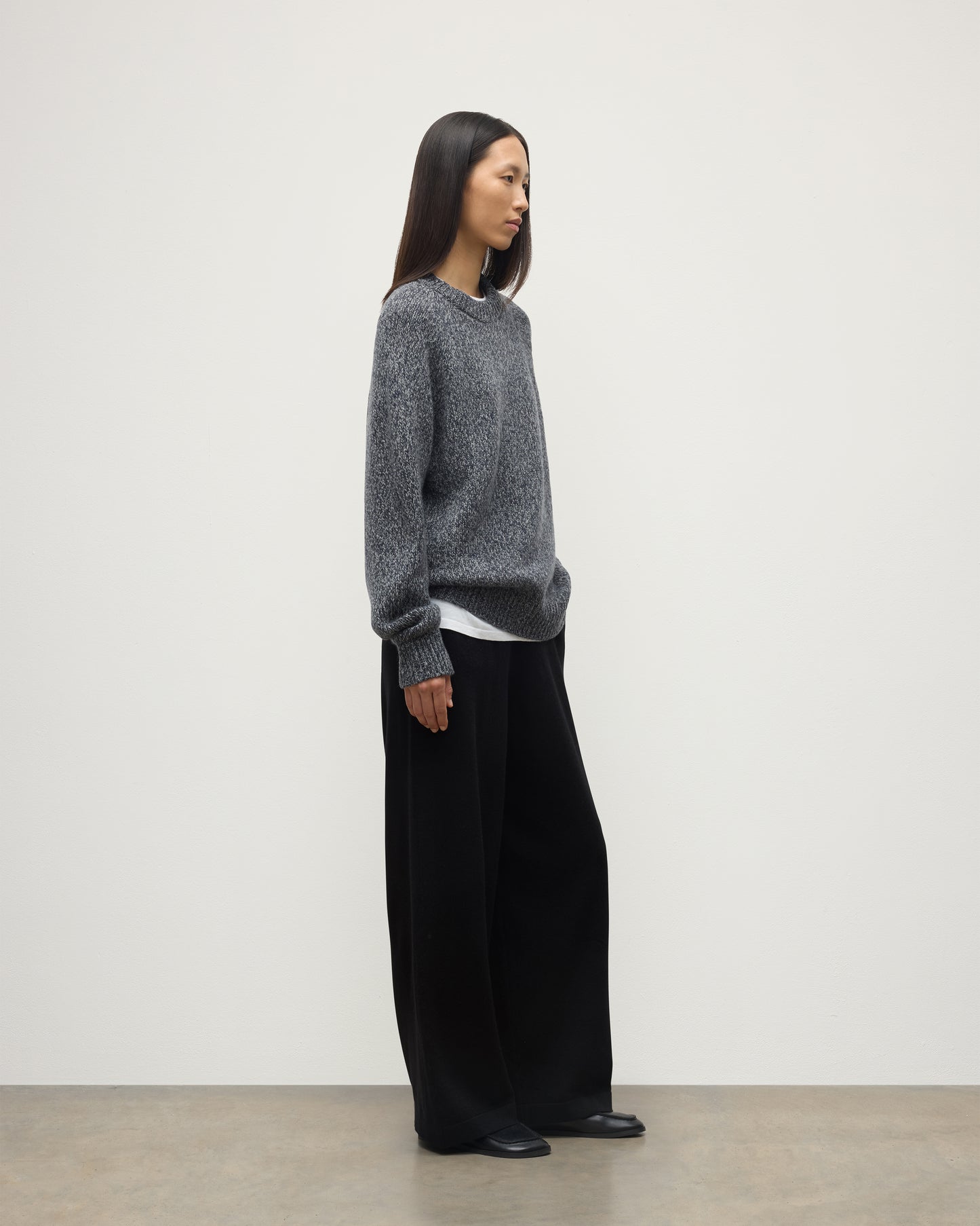 SIDE VIEW OF FEMALE MODEL WEARS JOHNSTONS OF ELGIN FYFE CREW SWEATER NAVY 100% CASHMERE WITH BLACK TROUSERS UAC05753006876