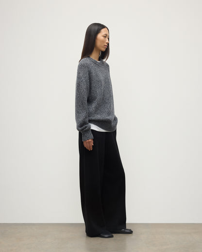 SIDE VIEW OF FEMALE MODEL WEARS JOHNSTONS OF ELGIN FYFE CREW SWEATER NAVY 100% CASHMERE WITH BLACK TROUSERS UAC05753006876