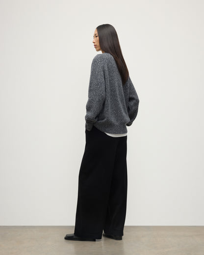 BACK OF FEMALE MODEL WEARS JOHNSTONS OF ELGIN FYFE CREW SWEATER NAVY 100% CASHMERE WITH BLACK TROUSERS UAC05753006876