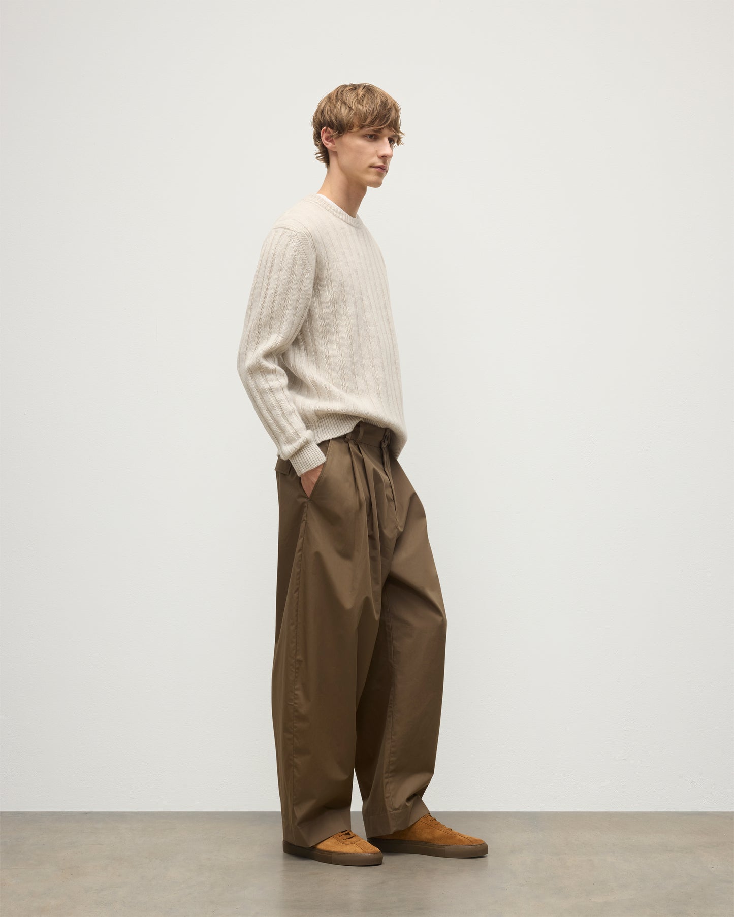 JOHNSTONS OF ELGIN MENS PEEL CREW SWEATER NATURAL 100% CASHMERE ON A MODEL OVER A WHITE T-SHIRT WITH BROWN TROUSERS KAC05751HA0402