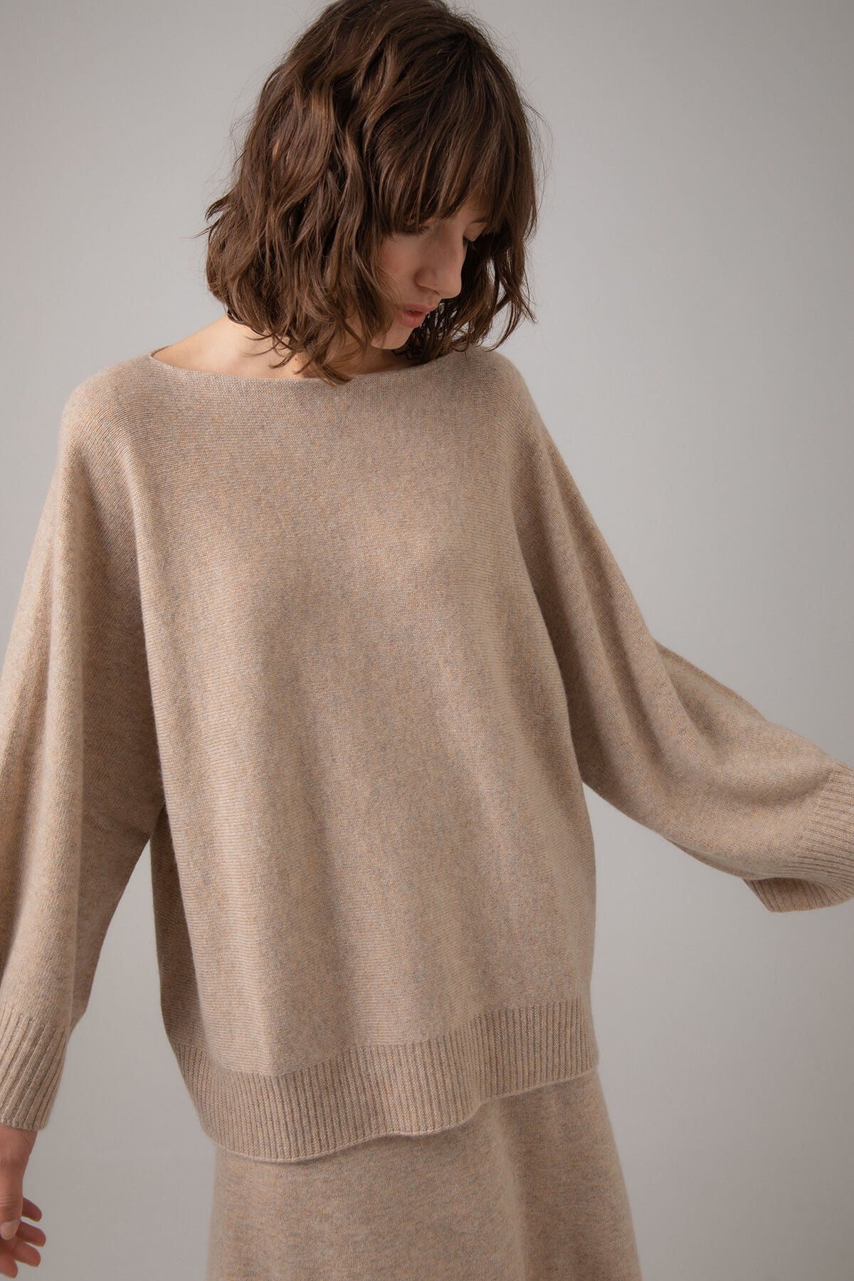 Johnstons of Elgin Boat Neck Cashmere Cape Jumper in Oatmeal on a grey background KAI05048HB0210