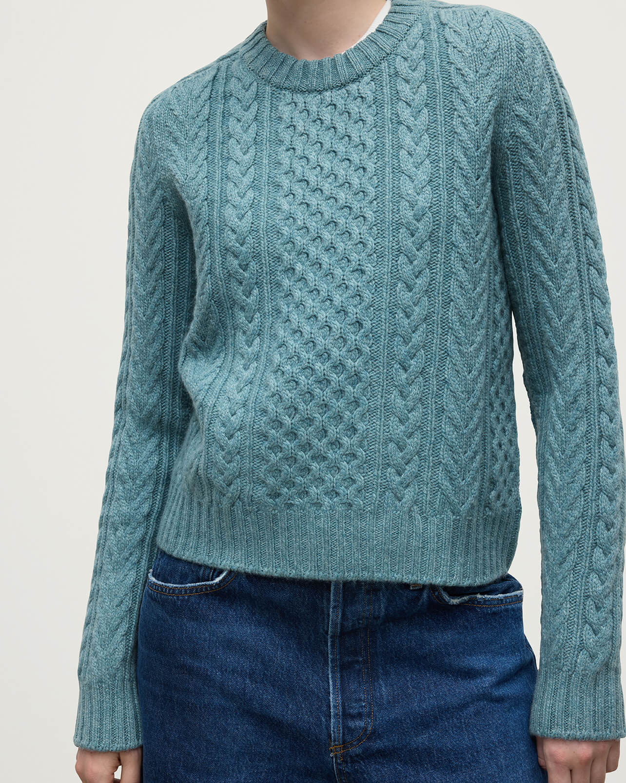 Model wears Johnstons of Elgin AW25 Women's Knitwear Seascape Aran Cable Green Cashmere Jumper Close up  KAI05086HC0038