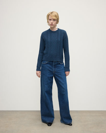 Model wears Johnstons of Elgin AW25 Women's Knitwear Heather Navy Aran Cable Navy Cashmere Jumper Front View KAI05086HD7321