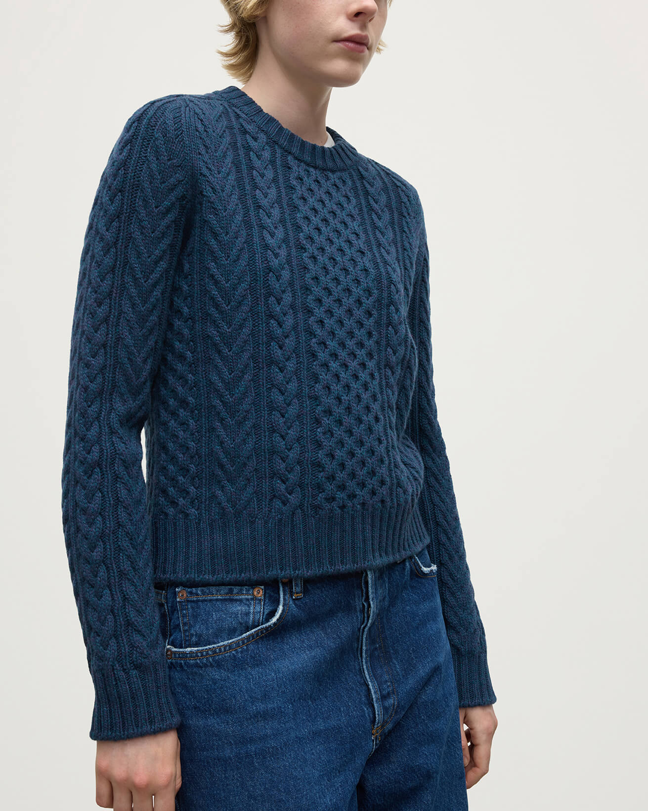 Model wears Johnstons of Elgin AW25 Women's Knitwear Heather Navy Aran Cable Navy Cashmere Jumper Details  KAI05086HD7321