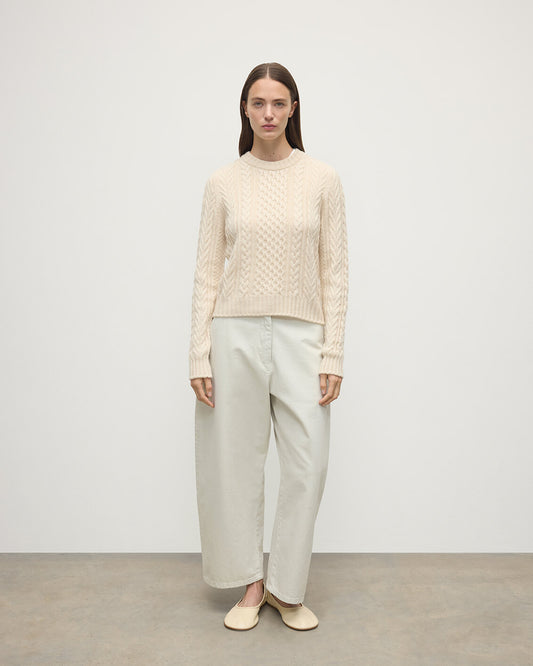 Model wearing Johnstons of Elgin AW25 Women's Knitwear Champagne Aran Cable Cream Cashmere Jumper Front View KAI05086SA0502