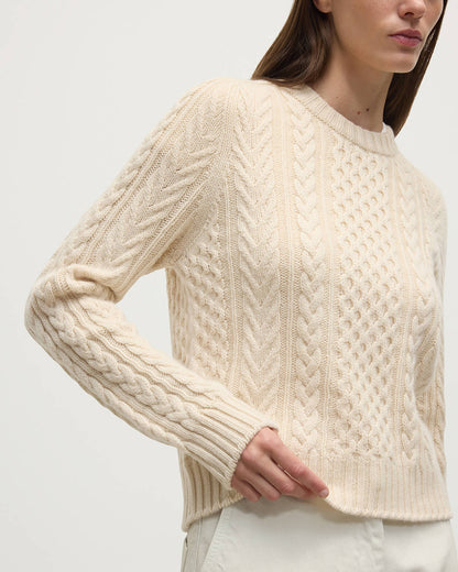 Model wearing Johnstons of Elgin AW25 Women's Knitwear Champagne Aran Cable Cream Cashmere Jumper Close Up  KAI05086SA0502