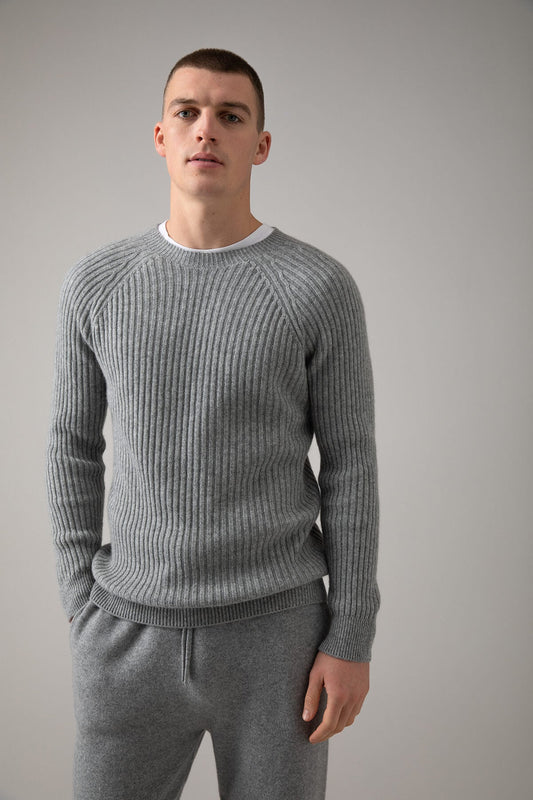 Johnstons of Elgin’s Men's Ribbed Cashmere Round Neck Jumper in Light Grey on model wearing grey joggers on a grey background KAI05105HA0308