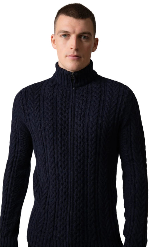 Johnstons of Elgin’s Men's Aran Cable Cashmere Zip Cardigan in Dark Navy on model on a grey background KAI05119Q23706