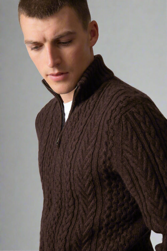 Johnstons of Elgin’s Men's Aran Cable Cashmere Zip Cardigan in Peat on model on a grey background KAI05119Q23708
