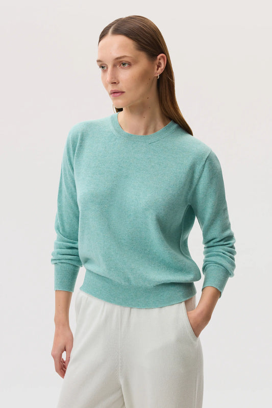 Model wearing Johnstons of Elgin SS25 Women's Knitwear Jade Classic Cashmere Round Neck jumper against a white backdrop KAI05142HC4284