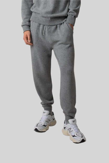 Johnstons of Elgin’s Men's Cashmere Donegal Sweatshirt in Light grey on model wearing matching grey joggers on a grey background KAA05147004542