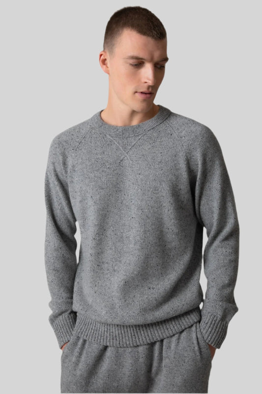 Johnstons of Elgin’s Men's Cashmere Donegal Sweatshirt in Light grey on model wearing matching grey joggers on a grey background KAA05147004542