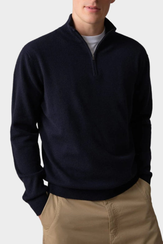 Johnstons of Elgin Men’s Cashmere Zip Neck Jumper in Dark Navy on model wearing camel trousers on grey background KAI05151SD7286