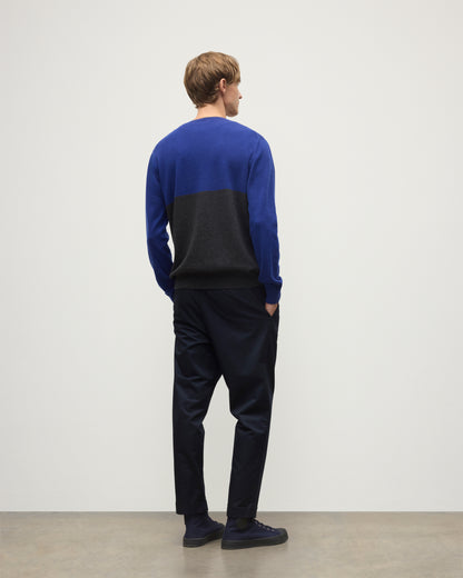 MODEL WEARING JOHNSTONS OF ELGIN MENS SHADED CREW SWEATER GREY 100% CASHMERE OVER A WHITE  T-SHIRT WITH NAVY TROUSERS KAI05232Q25945