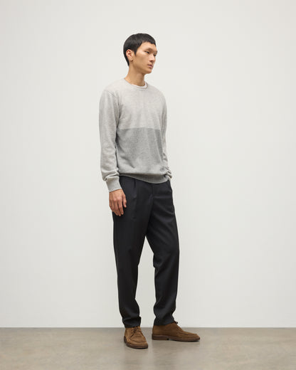 MODEL WEARING JOHNSTONS OF ELGIN MENS SHADED CREW SWEATER LIGHT GREY 100% CASHMERE OVER A WHITE T-SHIRT WITH GREY TROUSERS KAI05232Q25946