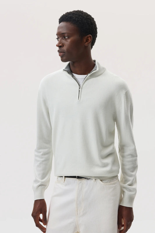 Model wearing Johnstons of Elgin SS25 Men's Knitwear White & Light Grey Contrast Trim Cashmere Zip Neck Jumper with white trousers  KAI05233Q25115