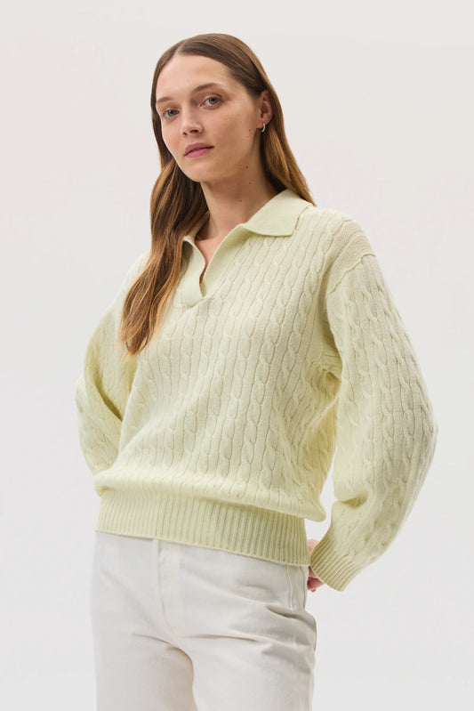 Model wearing Johnstons of Elgin SS25 Women's Knitwear Lemon Cropped Cable Cashmere Jumper  on a light studio backdrop KAI05246SA0145