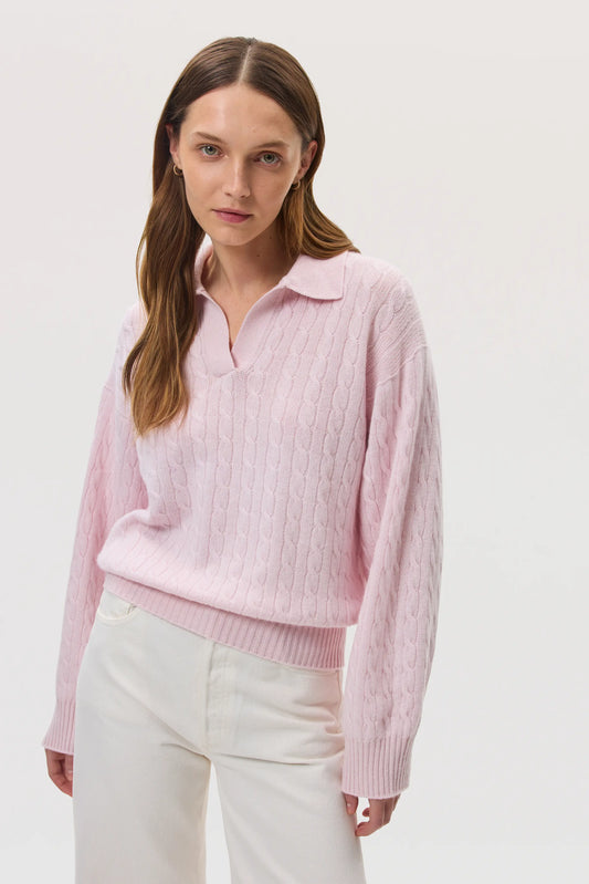 Model wearing Johnstons of Elgin SS25 Women's Knitwear Rose Cropped Cable Cashmere Jumper on a white background  KAI05246SE0208