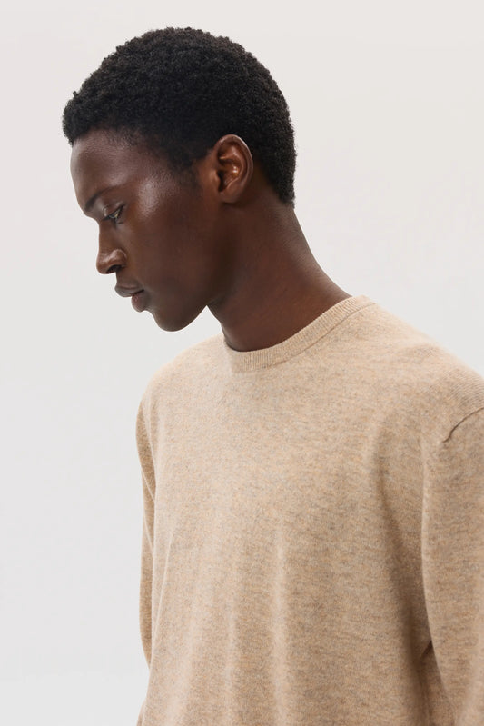 Male model wearing Johnstons of Elgin SS25 Men's Knitwear Oatmeal Classic Cashmere Round Neck Jumper KAI05265HB0210