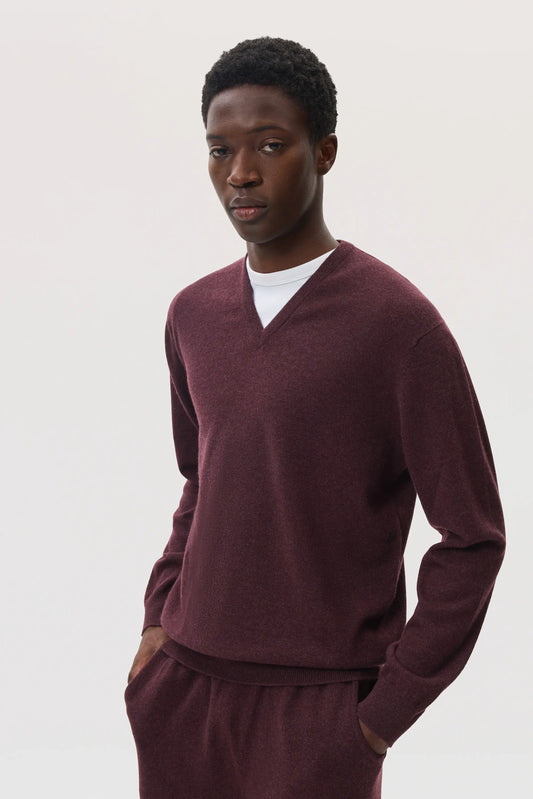 Model wearing Johnstons of Elgin SS25 Men's Knitwear Rosewood Classic Cashmere V Neck Jumper with matching cashmere joggers KAI05266SB7089