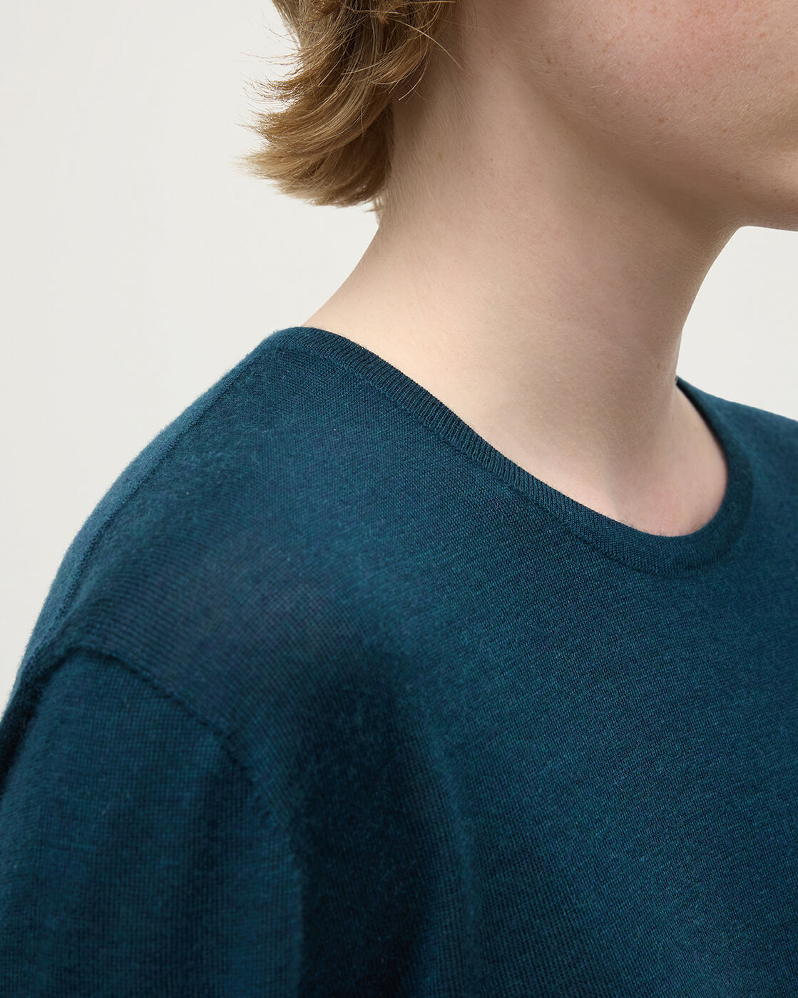 Model wearing Johnstons of Elgin AW25 Women's Knitwear Bottle Green Superfine Cashmere Green Jumper neckline detail KAI05318SC7344