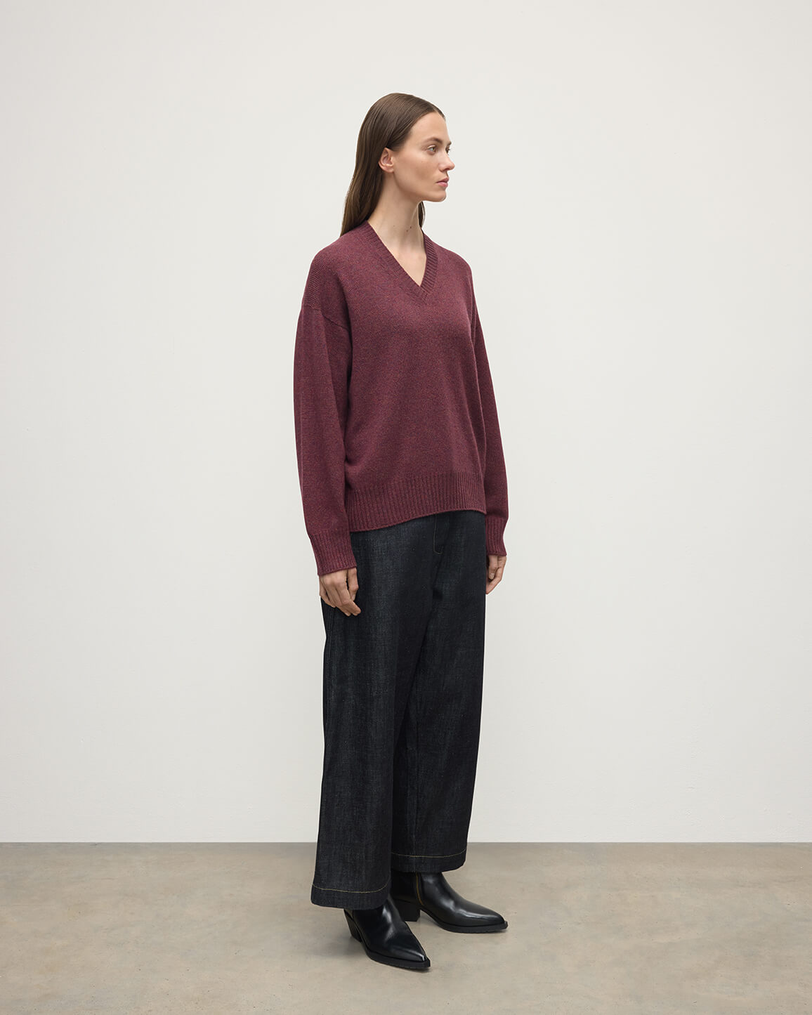 Model wearing Johnstons of Elgin AW25 Women's Knitwear Damson Gauzy Cashmere Purple V Neck Jumper Side View KAI05323HE7064