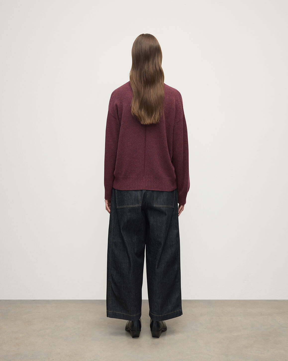 Model wearing Johnstons of Elgin AW25 Women's Knitwear Damson Gauzy Cashmere Purple V Neck Jumper Back View KAI05323HE7064