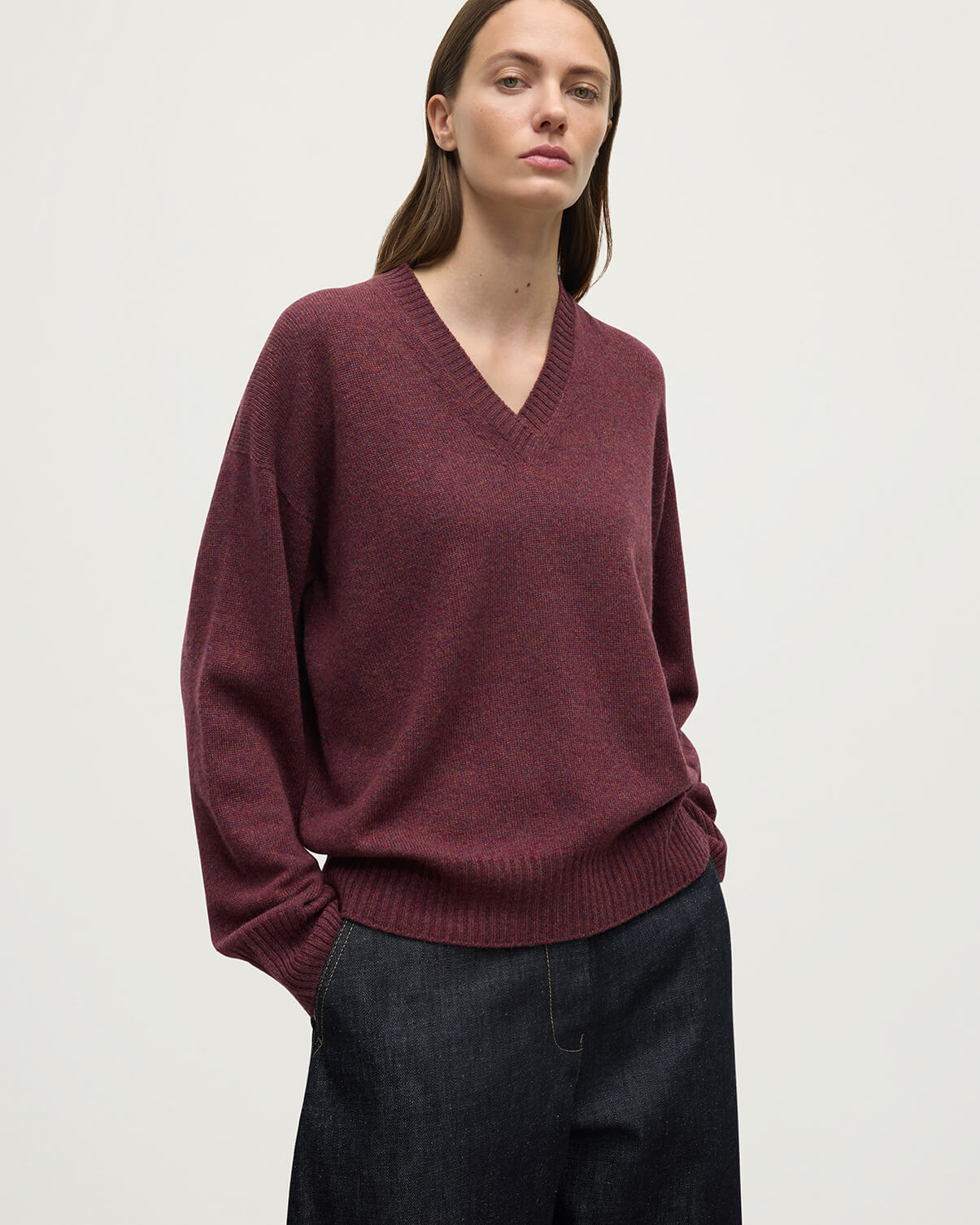 Model wearing Johnstons of Elgin AW25 Women's Knitwear Damson Gauzy Cashmere Purple V Neck Jumper Close Up KAI05323HE7064