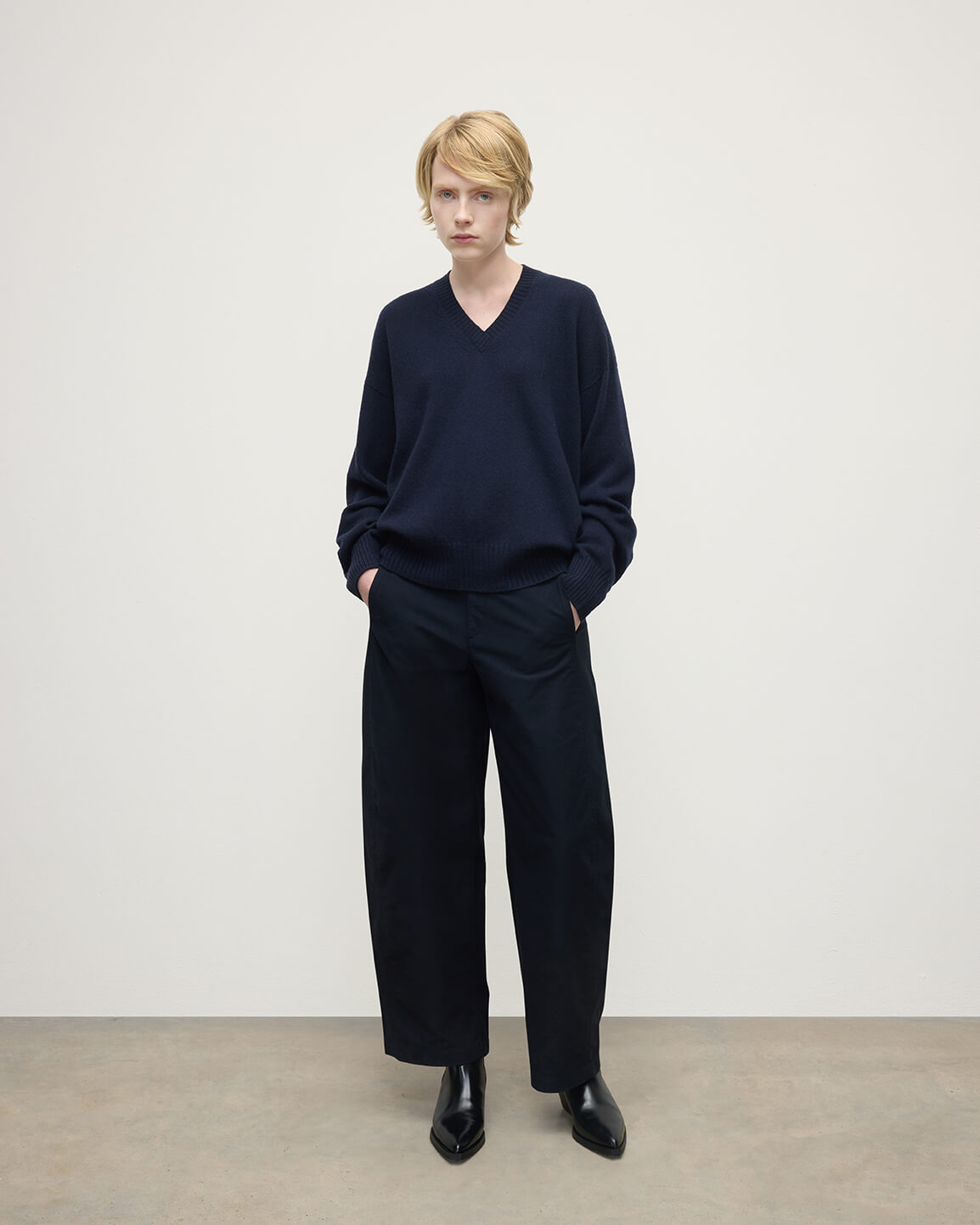 Model wearing Johnstons of Elgin AW25 Women's Knitwear Dark Navy Gauzy Cashmere Navy V Neck Jumper Front View KAI05323SD7666