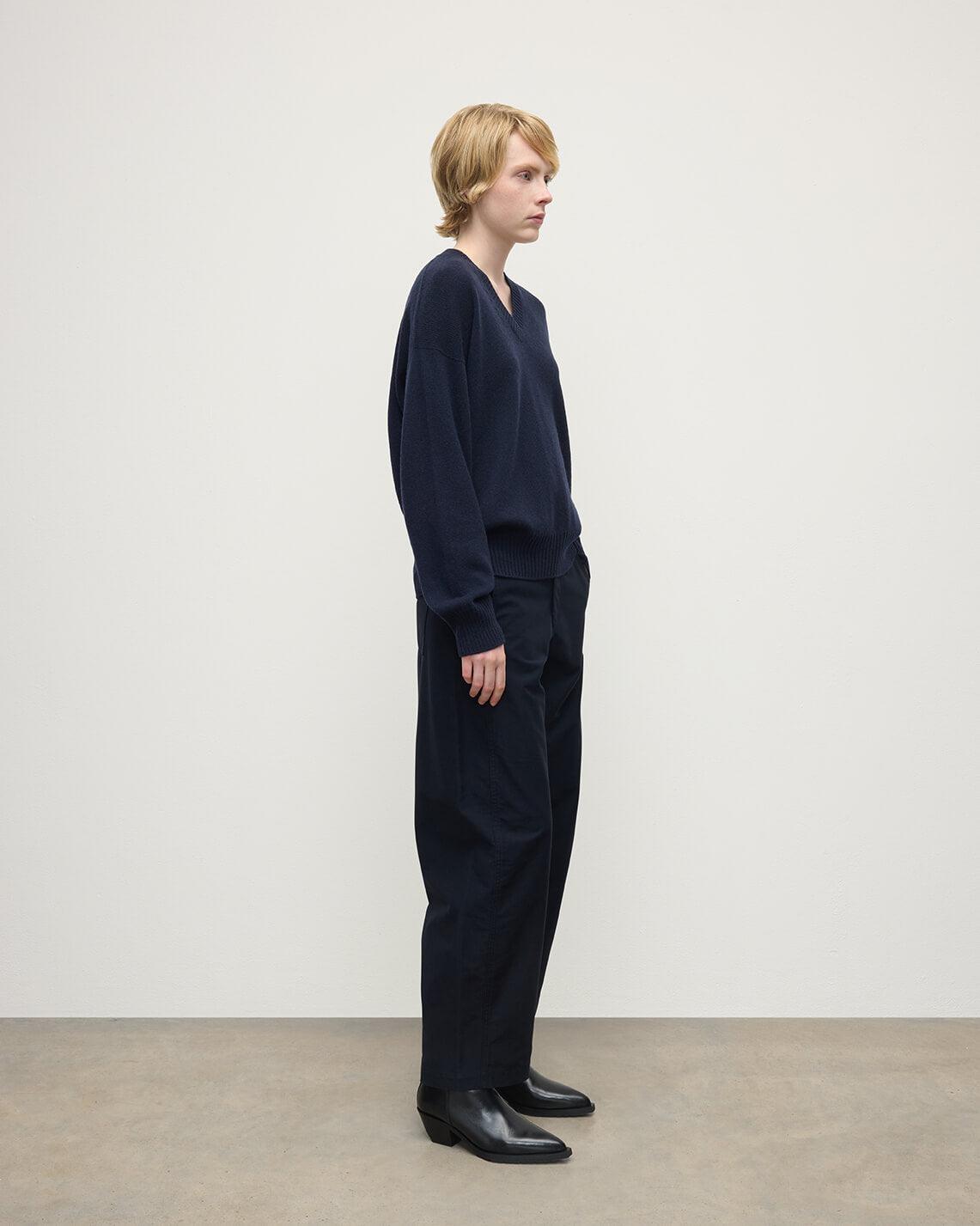 Model wearing Johnstons of Elgin AW25 Women's Knitwear Dark Navy Gauzy Cashmere Navy V Neck Jumper Side View KAI05323SD7666