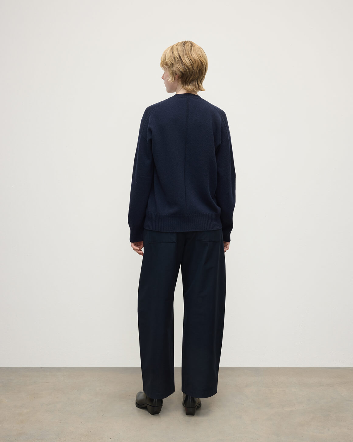 Model wearing Johnstons of Elgin AW25 Women's Knitwear Dark Navy Gauzy Cashmere Navy V Neck Jumper Back View KAI05323SD7666