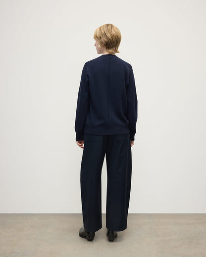 Model wearing Johnstons of Elgin AW25 Women's Knitwear Dark Navy Gauzy Cashmere Navy V Neck Jumper Back View KAI05323SD7666