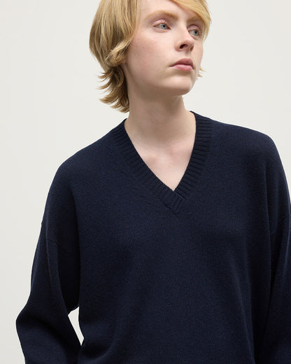 Model wearing Johnstons of Elgin AW25 Women's Knitwear Dark Navy Gauzy Cashmere Navy V Neck Jumper Close Up KAI05323SD7666