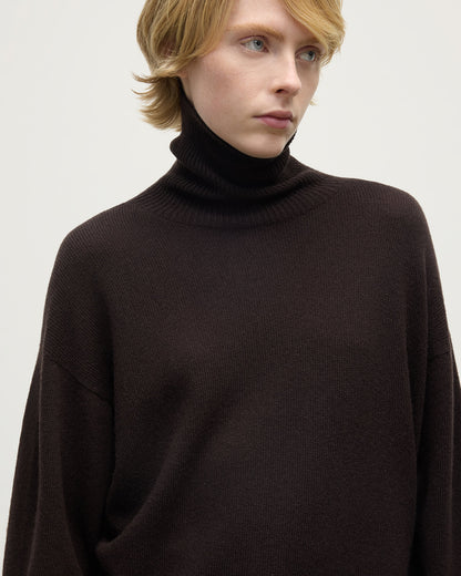 Model wearing Johnstons of Elgin AW25 Women's Knitwear Molasses Gauzy Cashmere Brown Roll Neck Jumper Close Up KAI05324SB7290