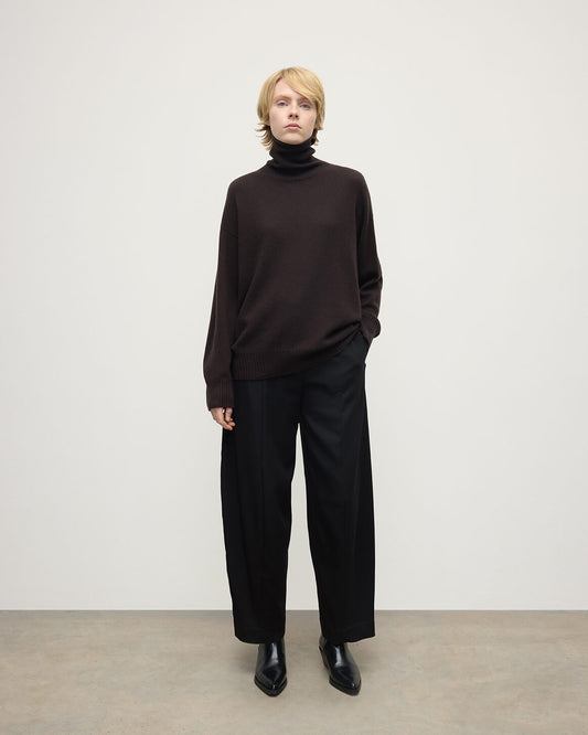 Model wearing Johnstons of Elgin AW25 Women's Knitwear Molasses Gauzy Cashmere Brown Roll Neck Jumper Front View KAI05324SB7290