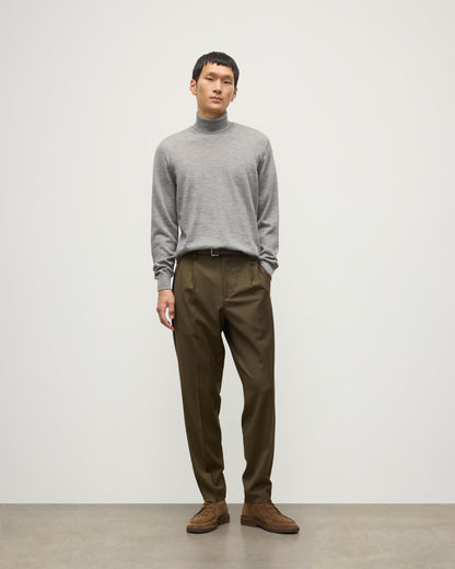 MODEL WEARS JOHNSTONS OF ELGIN MENS SUPERFINE FIN ROLL COLLAR GREY 100% SUPERFINE CASHMERE WITH OLIVE GREEN TROUSERS KAI05333HA4253