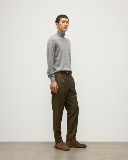 MODEL WEARS JOHNSTONS OF ELGIN MENS SUPERFINE FIN ROLL COLLAR GREY 100% SUPERFINE CASHMERE WITH OLIVE GREEN TROUSERS KAI05333HA4253